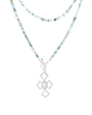 Necklace with beaded chain and diamond-shaped pendant on a white background