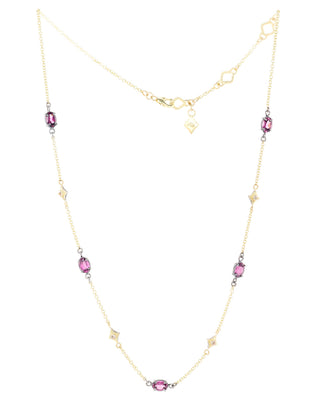Gold necklace with purple-pink (rhodolite garnet) gemstones on a white background